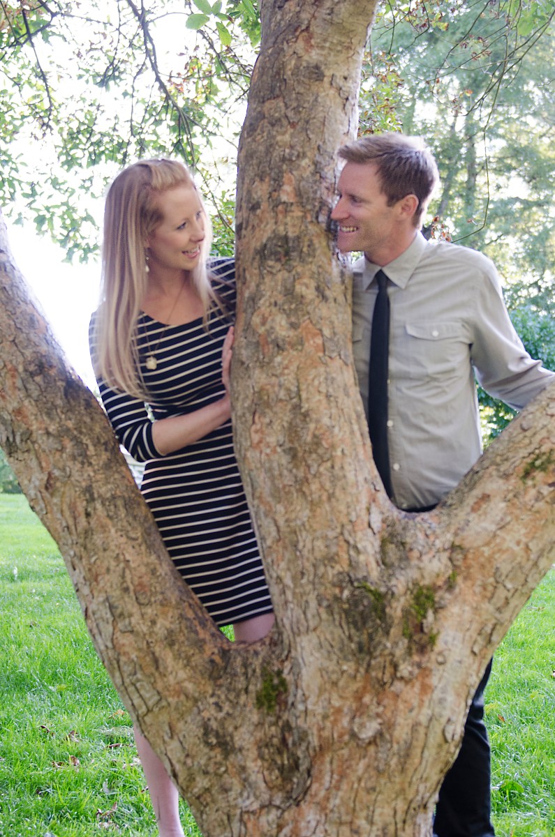 Bri and Ryan behind a tree.