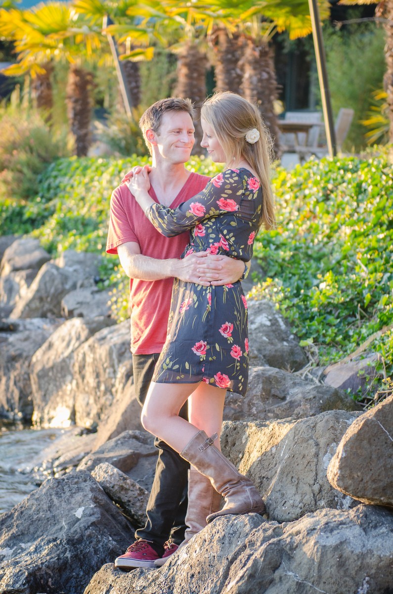 Bri and Ryan looking at each other on the beach.